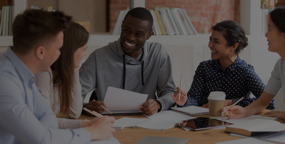 Diverse group of college students studying together